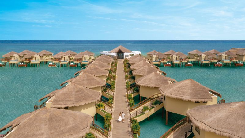 Couple walking on deck at Palafitos Overwater Bungalows