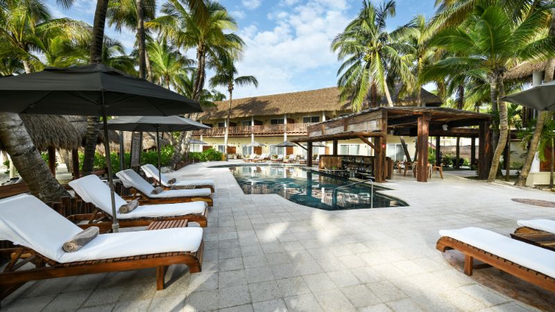 Poolside and sunbeds at El Dorado Maroma