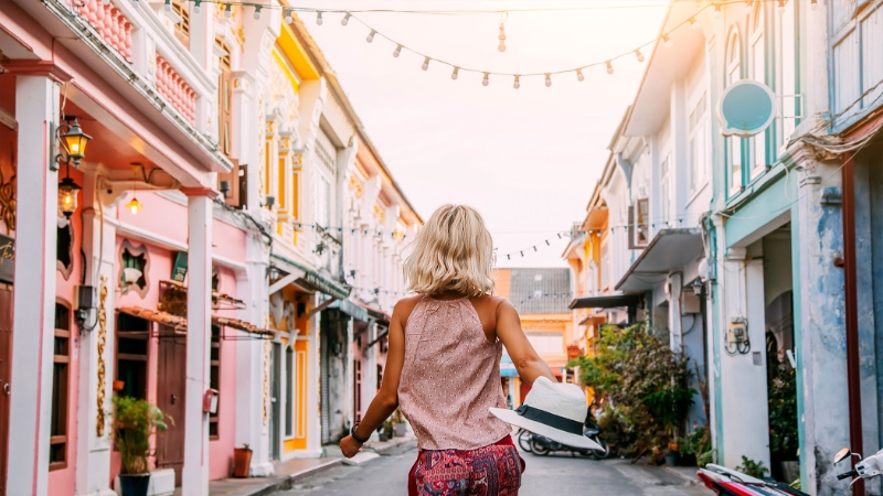 Girl Walking Through City Street