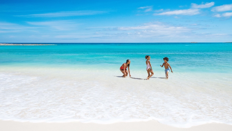 Family playing on the beach in Nassau and Paradise Island