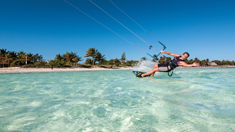 Woman kitesurfing in Cuba