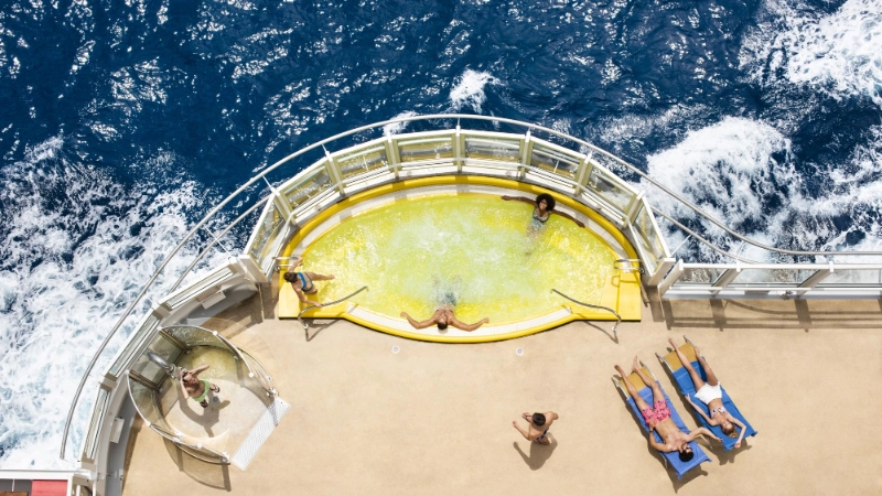 People relaxing in a hot tub and on lounge chairs at the stern of a costa People relaxing in a hot tub and on lounge chairs at the stern of a costa cruise ship overlooking the oceancruise ship overlooking the ocean