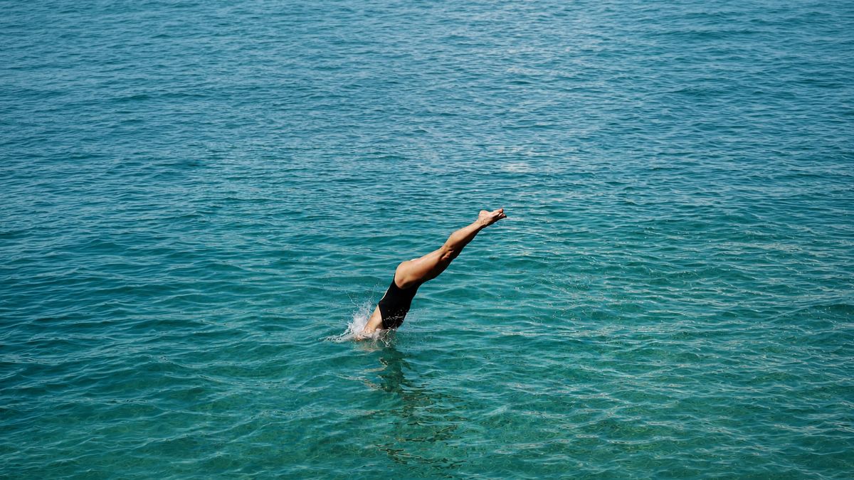 Lady plunging into pool at Bahia Principe Hotel Resort
