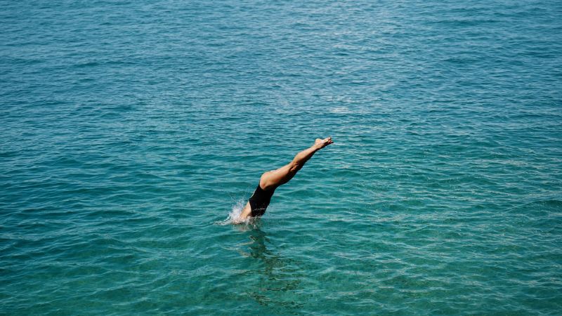 Lady plunging into pool at Bahia Principe Hotel Resort