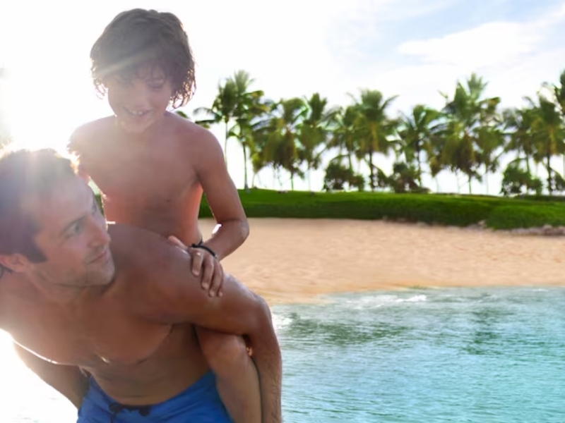 Dad Holding Son On Beach