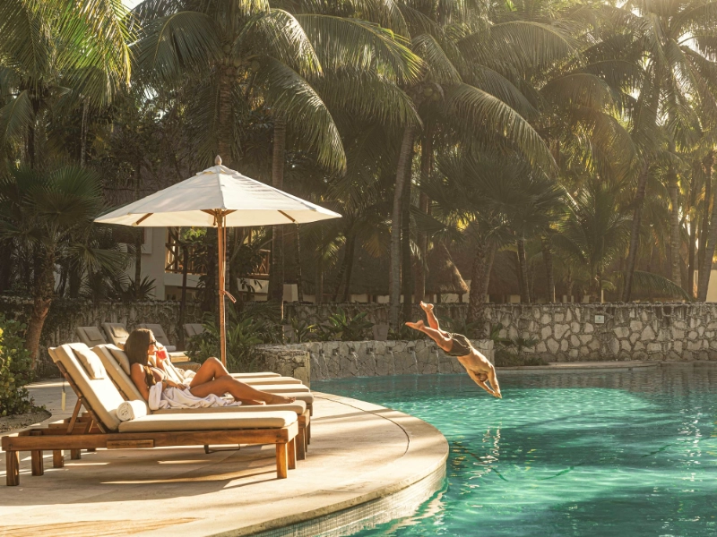 Couple enjoying the pool at Mahekal Beach Resort