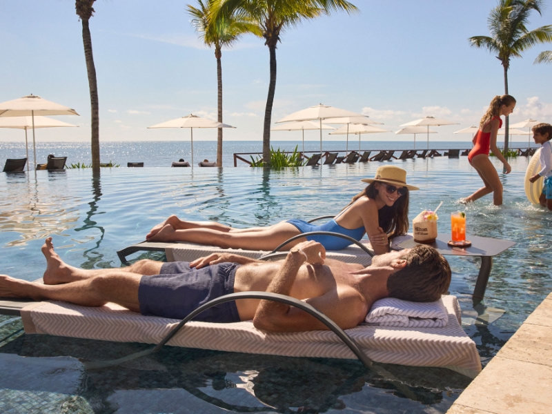 Family at the pool at Hilton Cancun All Inclusive Resort