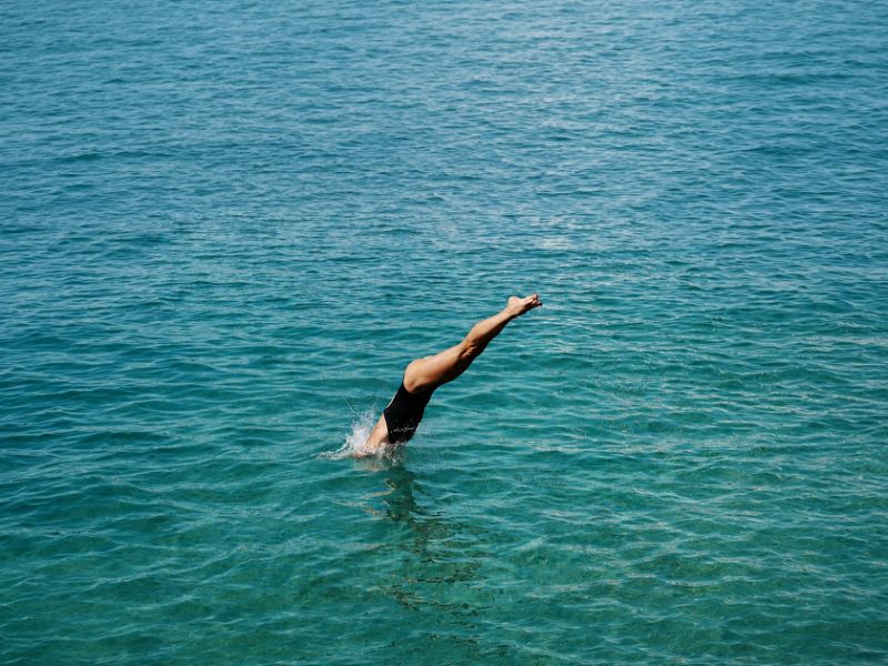 Lady plunging into pool at Bahia Principe Hotel Resort