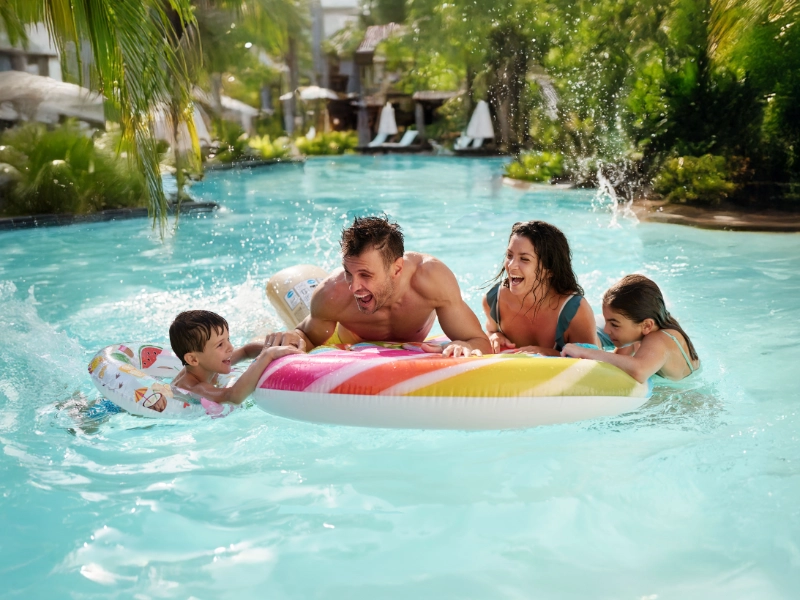 Famille heureuse jouant dans la piscine